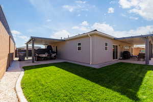 Rear view of house with a patio, stucco siding, and a fenced backyard