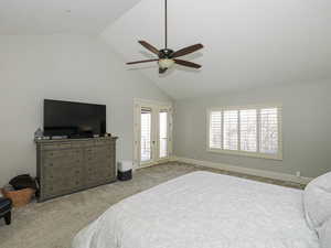 Bedroom featuring a ceiling fan, access to exterior, lofted ceiling, carpet, and french doors
