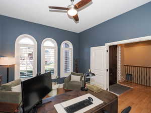 Office space with a ceiling fan and hardwood / wood-style flooring