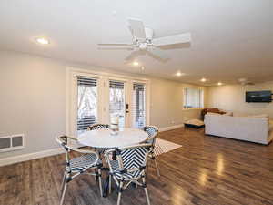Dining room featuring a ceiling fan, dark wood-type flooring, and recessed lighting