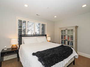 Bedroom featuring dark carpet and recessed lighting