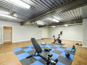 Workout room with finished concrete floors and a garage