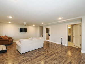 Living room featuring wood finished floors, ceiling fan, and recessed lighting