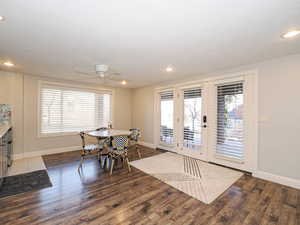 Dining area featuring dark wood-style flooring, a ceiling fan, plenty of natural light, and recessed lighting
