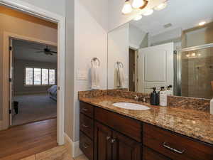 Full bathroom with vanity, a stall shower, and light tile patterned flooring