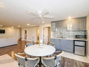 Dining area featuring ceiling fan, recessed lighting, light wood-type flooring, and wet bar