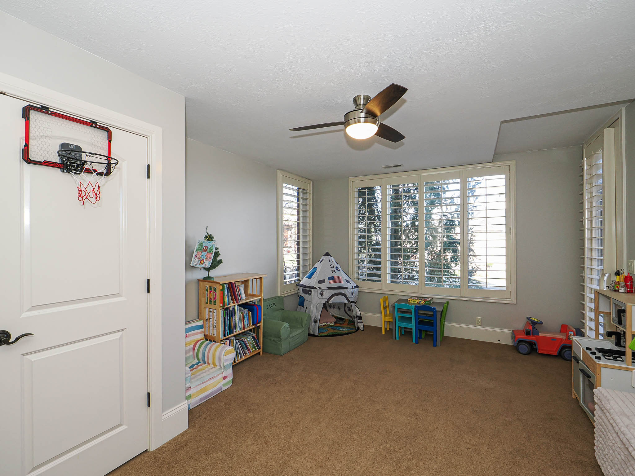 Playroom featuring ceiling fan and carpet flooring