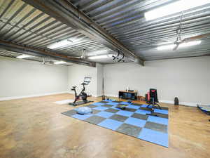 Workout area featuring concrete floors and baseboards