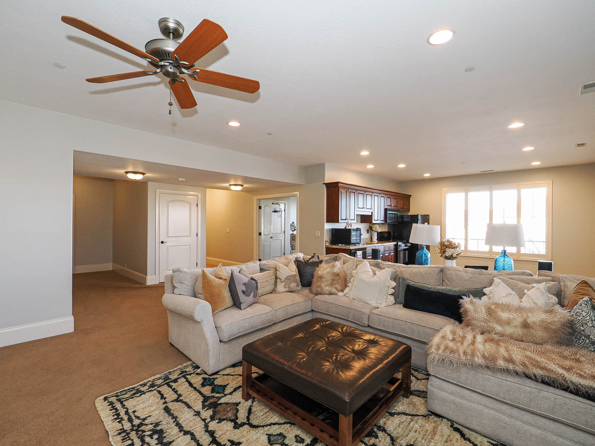 Living area with carpet floors, ceiling fan, and recessed lighting