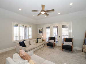 Living room with french doors, light colored carpet, a ceiling fan, plenty of natural light, and recessed lighting
