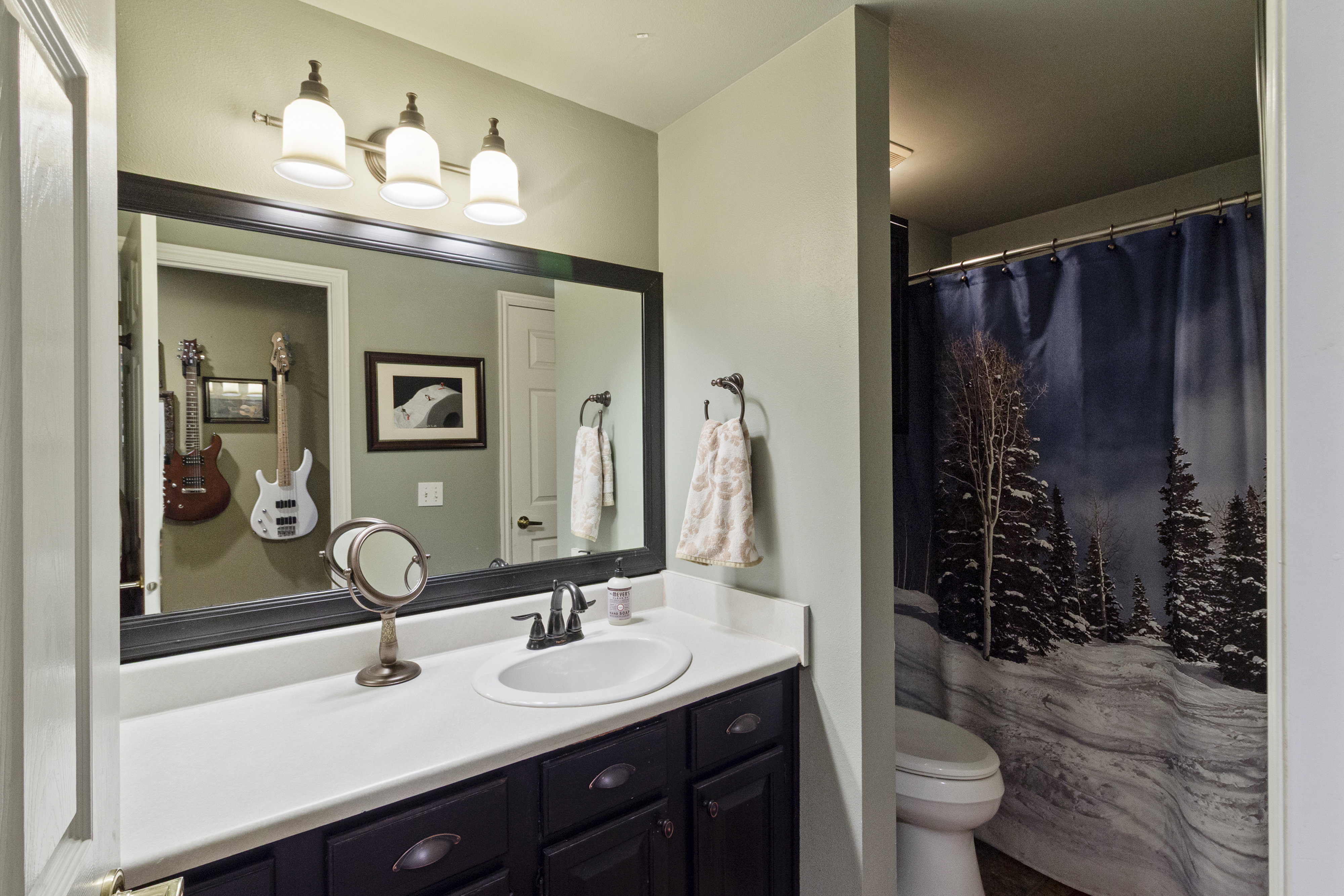 Bathroom with vanity and curtained shower