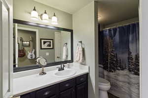 Bathroom with vanity and curtained shower
