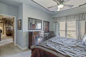 Carpeted bedroom featuring access to exterior and a ceiling fan