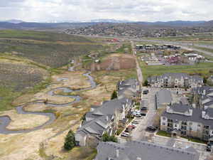 Aerial view of property and surrounding area featuring a mountainous background
