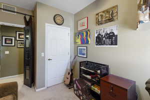 Office with light carpet and baseboards