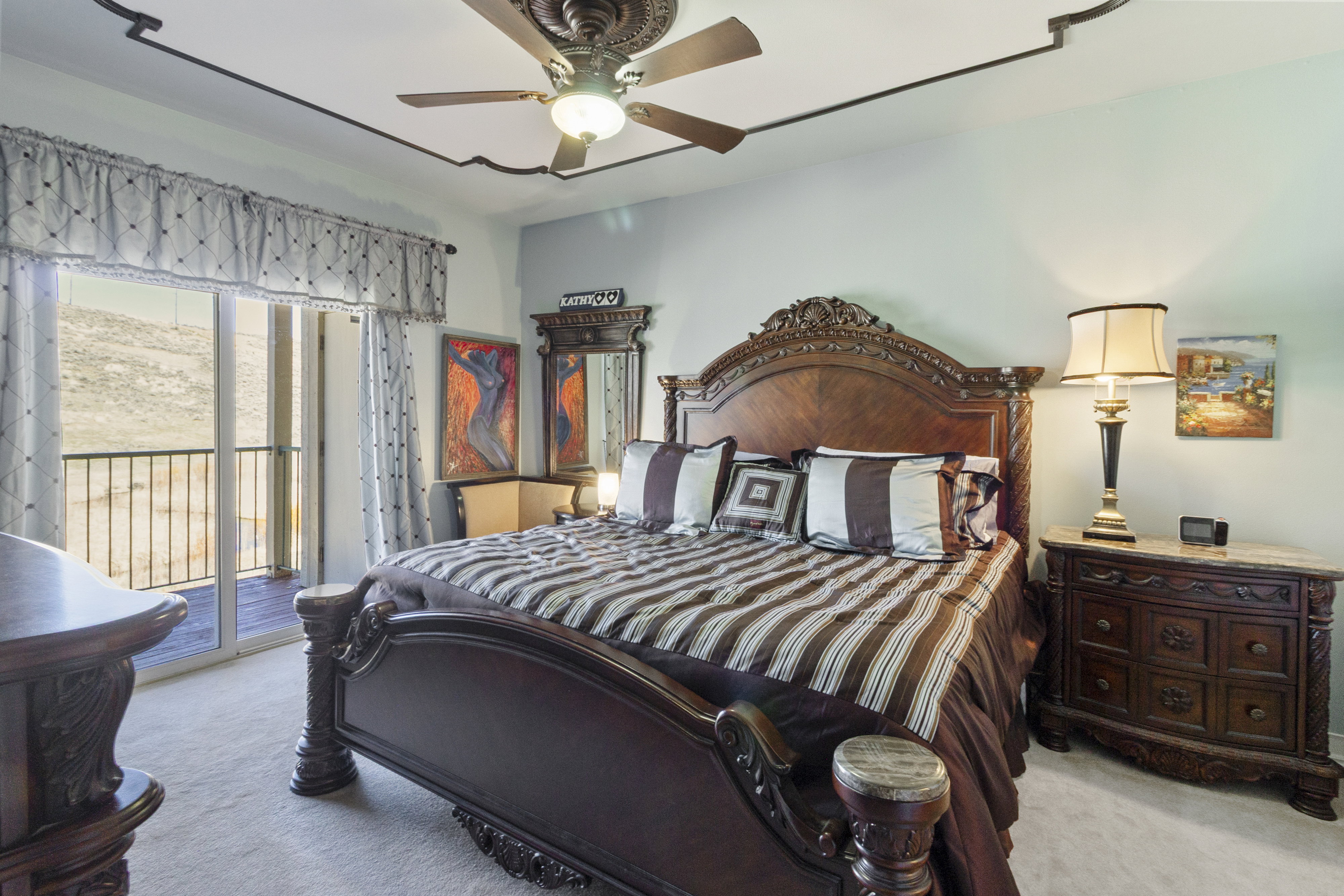 Bedroom with access to exterior, light carpet, and ceiling fan