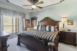 Bedroom with access to exterior, light carpet, and ceiling fan