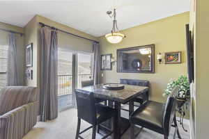 Dining space featuring light carpet and baseboards