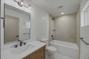 Full ensuite bath with vanity, shower / bathtub combination, and recessed lighting