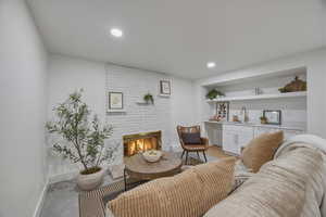 Living room featuring a brick fireplace and recessed lighting