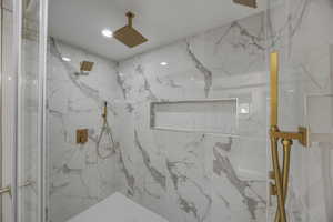 Bathroom with a marble finish shower