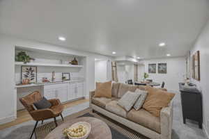 Living room with recessed lighting and light wood finished floors