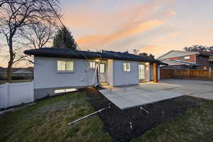 Back of house featuring a patio, brick siding, a fenced backyard, and entry steps