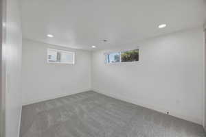 Basement with recessed lighting and carpet flooring