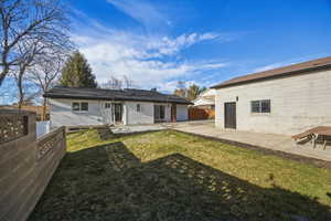 Rear view of house with a patio and a fenced backyard