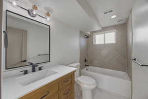 Bathroom with vanity, shower / tub combination, and light marble finish floors
