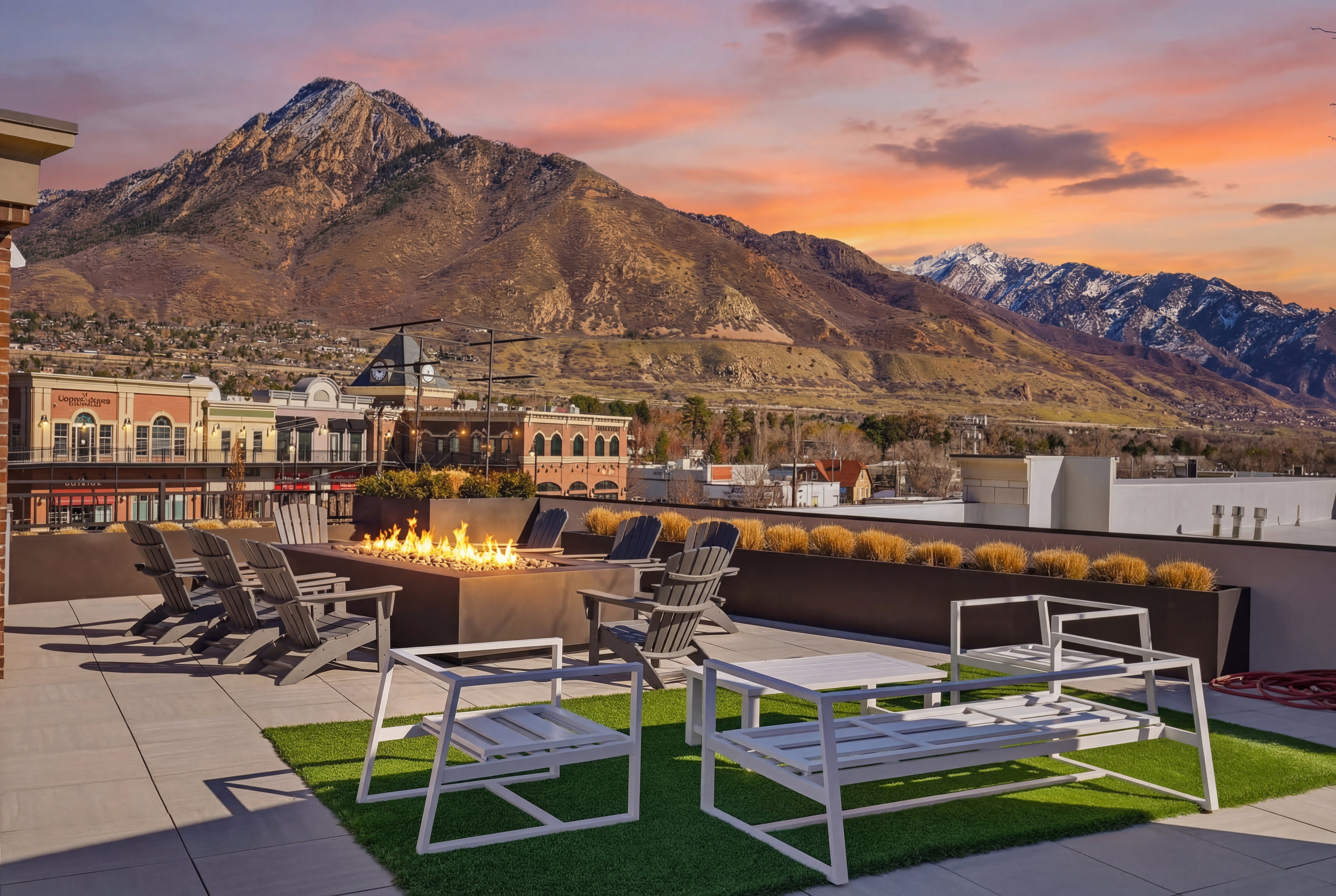 Patio terrace at dusk with a fire pit, a patio, and a mountain view