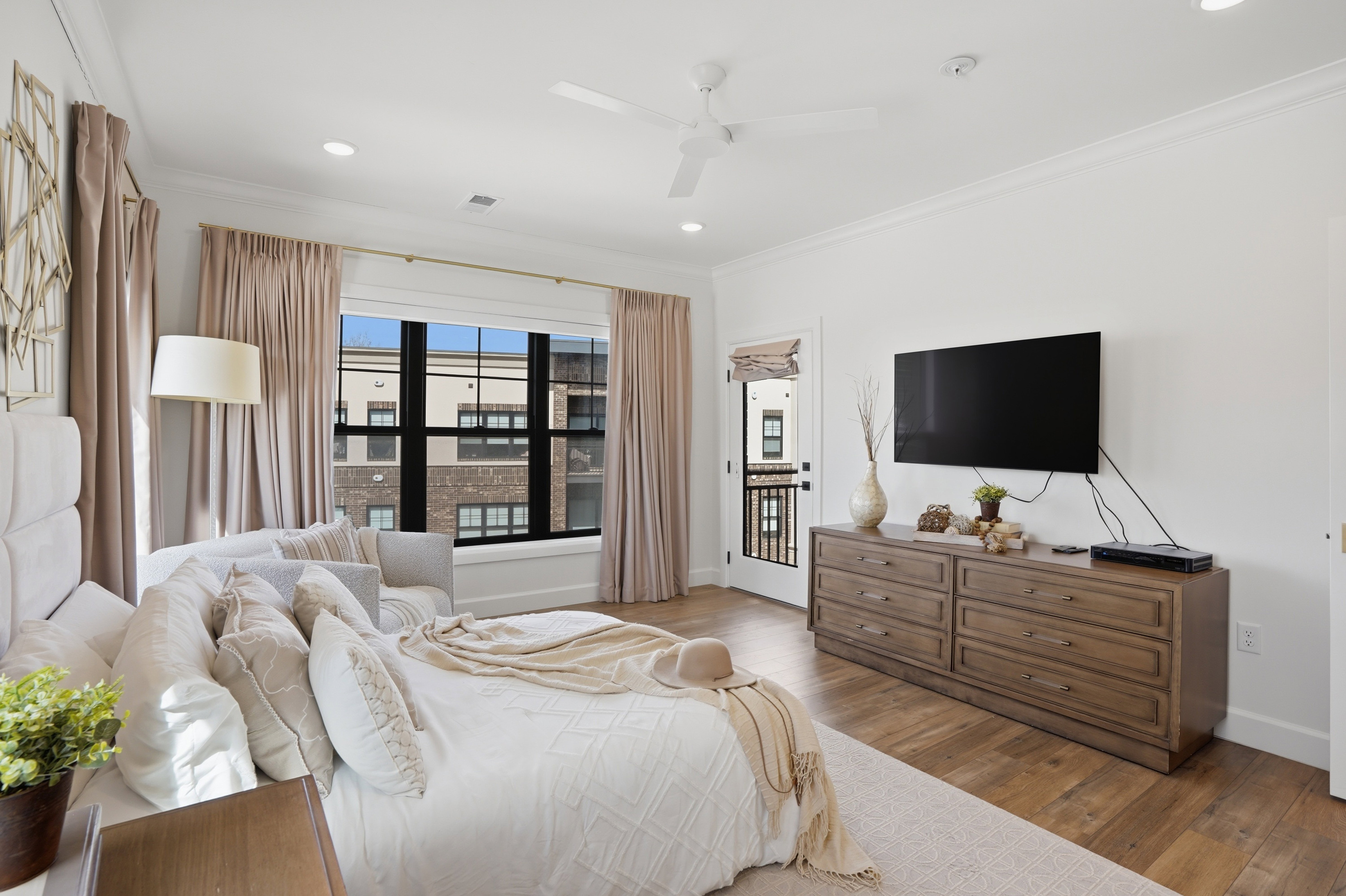 Primary Bedroom with ensuite bathroom, walk in closet, and private door to balcony