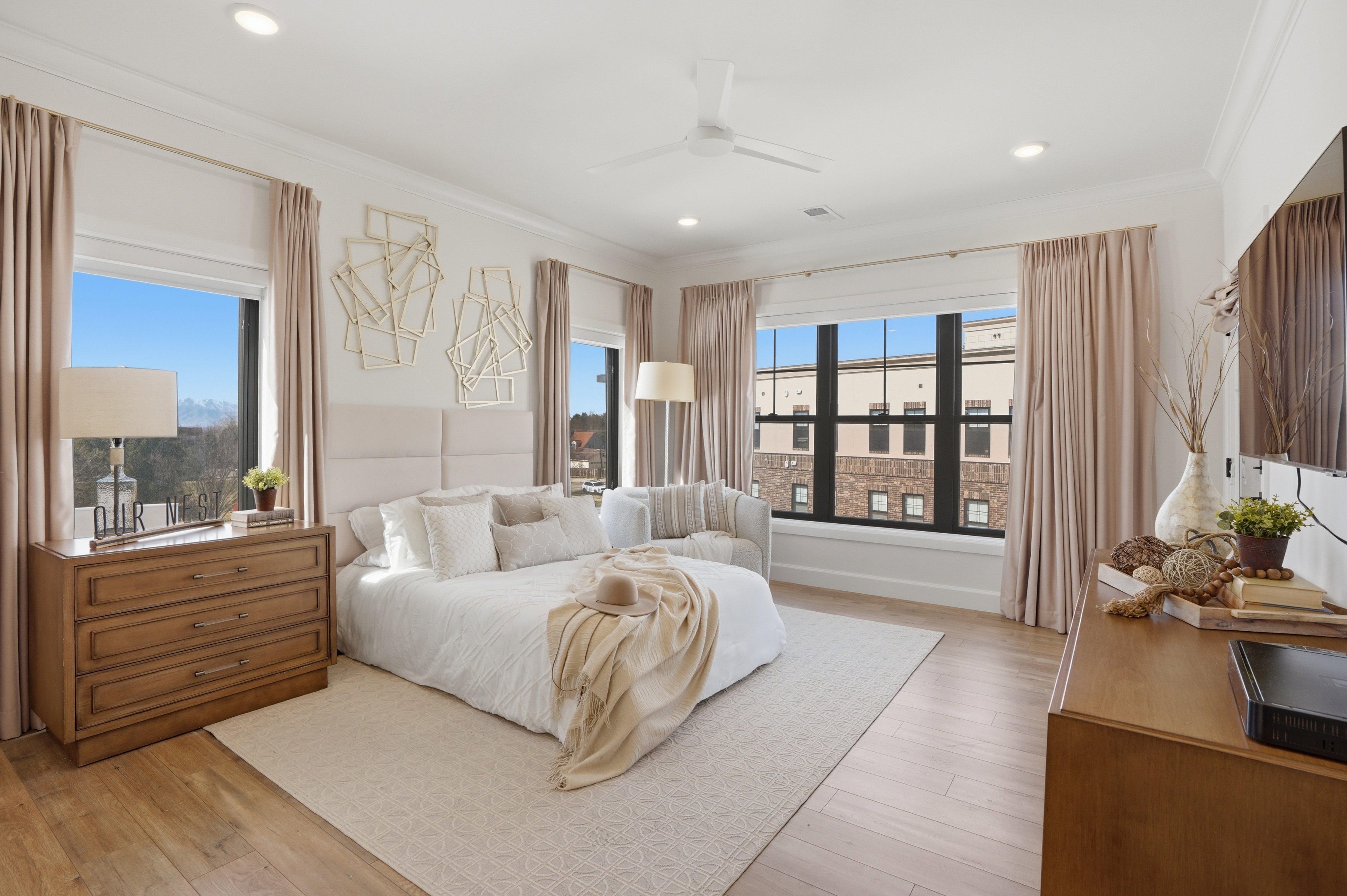 Primary Bedroom with ensuite bathroom, walk in closet, and private door to balcony