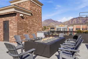View of patio / terrace with a fire pit and a mountain view