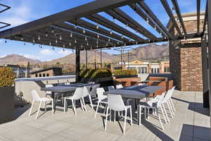 View of patio / terrace with a mountain view and outdoor dining space