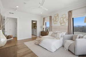 Primary Bedroom with ensuite bathroom, walk in closet, and private door to balcony