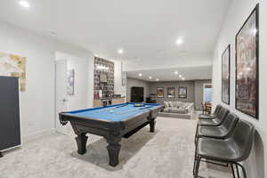 Playroom with billiards, recessed lighting, light colored carpet, and bar area