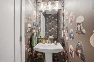 Bathroom featuring wallpapered walls