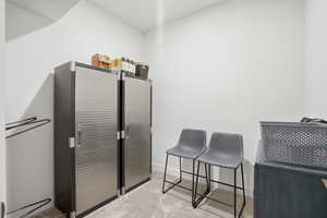 Misc room with light carpet and baseboards