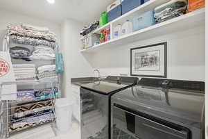 Laundry area featuring a sink and washer and dryer