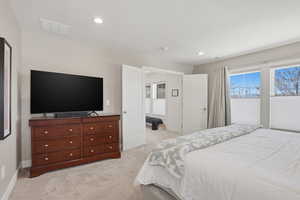 Primary Bedroom featuring light carpet and recessed lighting