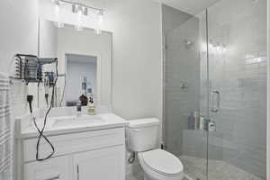 Bathroom featuring vanity and a stall shower
