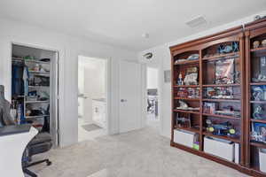 Bedroom currently used as Home office featuring light carpet