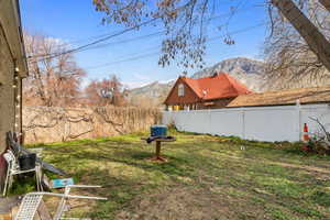 Fenced backyard featuring a mountain view