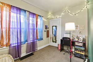 Office with light colored carpet and baseboards