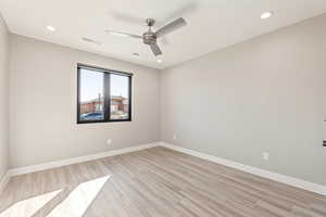 Empty room with light wood finished floors, recessed lighting, and ceiling fan