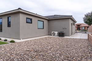 View of home's exterior featuring stucco siding and an ac unit