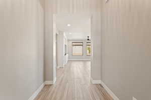 Hallway featuring wood finish floors and recessed lighting