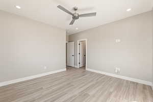 Unfurnished bedroom featuring light wood-style flooring, ceiling fan, and recessed lighting
