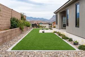 Fenced backyard with a mountain view and a patio area